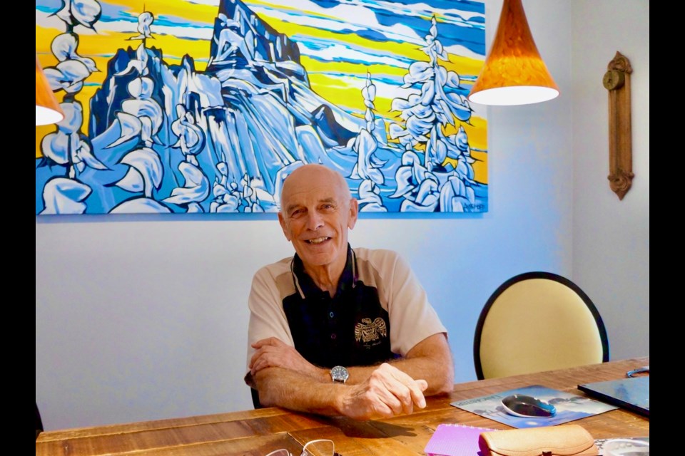 Rae Simpson in his home last week, with the painting by Squamish's Andy Anissimoff behind him.  HIs computer mouse pad is a Lancaster.                           